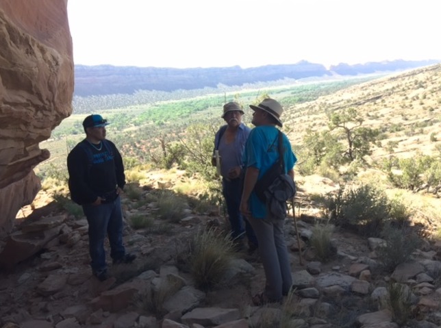 Willie Grayeyes of Utah Dine Bikeyah, Nickolaus Lewis, Council Member of the Lummi Nation, and Wayne Hoskisson with the Sierra Club Utah Chapter talk about Bears Ears in the shadow of Walnut Knob in the monument.