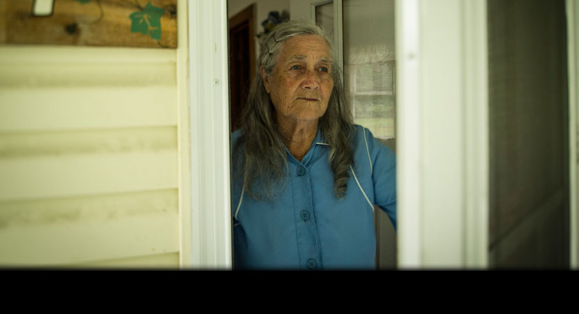 Quinnie Richmond at home. "Sometimes it gets lonely now, a little bit," her son, Roger Richmond said. "Momma will be sitting on the couch, and she'll say, 'There ain't no more traffic."' | Ami Vitale/Panos Pictures
