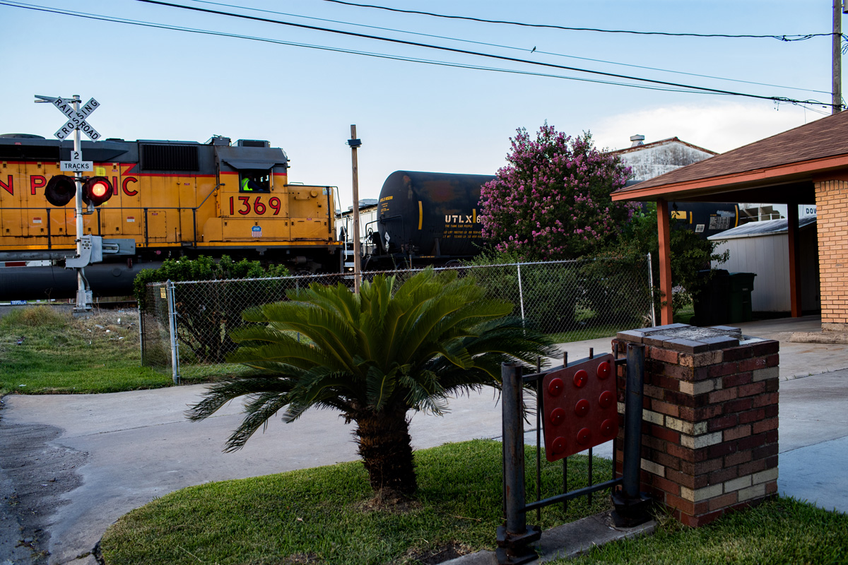 Freight locomotive passing grade crossing in Pleasantville section of Houston.