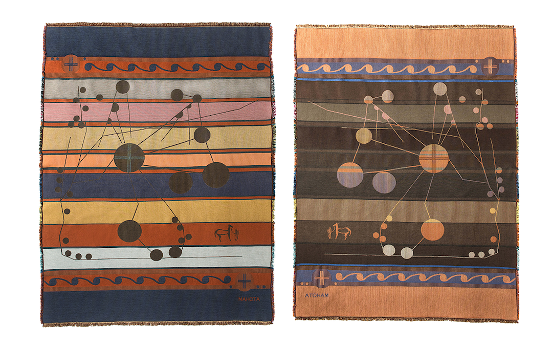 A striped blanket adorned with a stylized version of a historic Chickasaw map